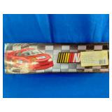 2005 NASCAR "Flat-Out" Mug Set featuring colorful stock car graphics and includes two coffee mugs.