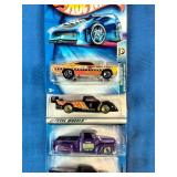 Stack of six carded Hot Wheels die-cast cars packaged from the late 1990s through the mid-2000s.