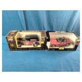 Pair of vintage die-cast vehicle collectibles in their original window display boxes.