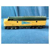 HO Scale models of a Chicago and North Western Railway F7 diesel locomotive and matching box car.