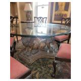Beautifully Carved Wooden Dining Table with Winged Lion Base and Round Glass Top