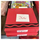 Stack of Two Red Boxes with Wavy Black Line Design