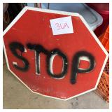 Red Octagonal STOP Sign with Graffiti and Auction