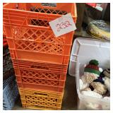 Stacked Orange and Yellow Plastic Milk Crates with