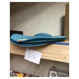 Stack of Teal Woven Round Placemats