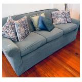 SLIP COVERED SOFA - SHOWS WEAR
