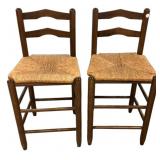 Ladder-back bar stools featuring woven rush seats