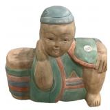 Painted wooden sculpture depicting a lucky baby