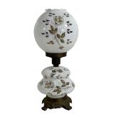 Vintage electric hurricane lamp featuring a white