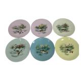 Includes six porcelain plates, each featuring a