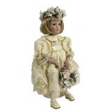 Features a porcelain head, hands, and feet with a