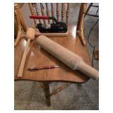 Two wooden pestles and a metal walnut-pecan