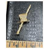 Gold tone top hat pin brooch with clear stones