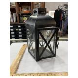 Black metal lantern with glass, signs of wear,