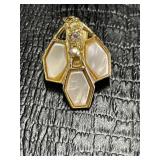 Gold tone pendant with mother of pearl and clear