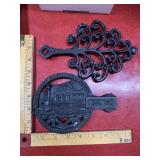 2 Vintage metal trivets, one design, one train