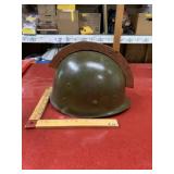 Vintage military helmet with wooden ornament on