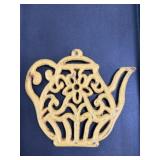 Vintage yellow cast iron trivet some paint wear