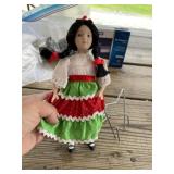 Vintage 9 inch porcelain doll with metal stand