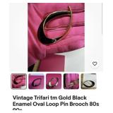 Vintage Trifari tm gold tone black enamel oval