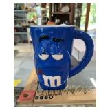 Vintage blue M&M Mug, paint is faded, scratched,