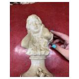 Two vintage white statues of a boy and girl