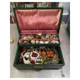 Vintage green jewelry box with jewelry inside