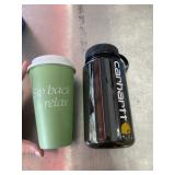 Carhartt water bottle and green to-go coffee cup
