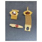 2 gold toned cufflinks and tie clip with red gems