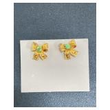 Gold toned bow earrings with green gem
