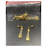 Many gold tone lighthouse dangling earrings