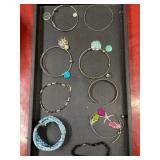 9 silver tone and multicolored bracelets