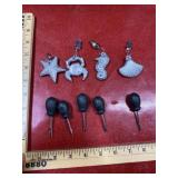 4 silver tone charms with 5 seam rippers