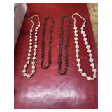 Hawaiian shell necklaces and seed necklaces, one