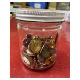 Glass jar with lots of old trinkets, pins,