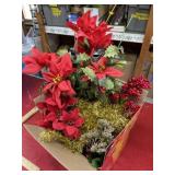 Box of Christmas decor and fake greenery
