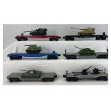 Six postwar Lionel O Gauge flat cars with military loads