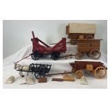 Group of five wooden and cast iron horse drawn toy wagons and cart
