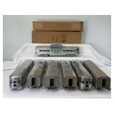 Seven postwar American Model Toys passenger cars, baggage, diner, vista dome, coaches, observations