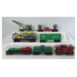 Group of Marx O Gauge 8-wheel plastic freight cars; double searchlight, auto carrier, flat w/autos, box, tank, wrecker, caboose