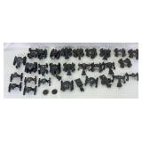 Group of twenty-eight prewar and postwar Lionel O Gauge operating coupler truck assemblies/frames parts/restoration