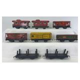 Group of eight Marx O Gauge 4-wheel 6" freight cars; flat, gondola, reefer, hoppers, cabooses