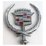 A Vintage Cadillac Hood Ornament and Two Sterling