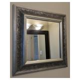 Square wall mirror with ornate silver-toned frame