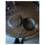 Cast iron frying pan and large lid.