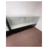 Glass shelving case on wheels. 7 foot long.