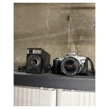 Vintage Kodak camera and Canon camera