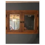 Wood cabinet with glass doors and 3 shelves.