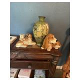 Green vase with floral decor and 2 dog statues.