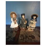 3 doll ceramic figurines.